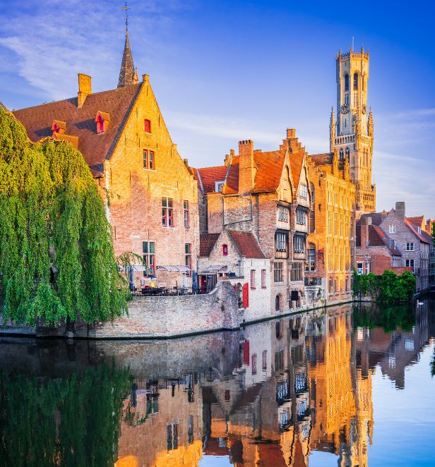 Charming old-town buildings reflected in a peaceful canal at sunset