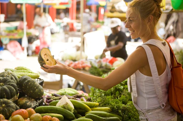 Woman shopping at colorful outdoor market