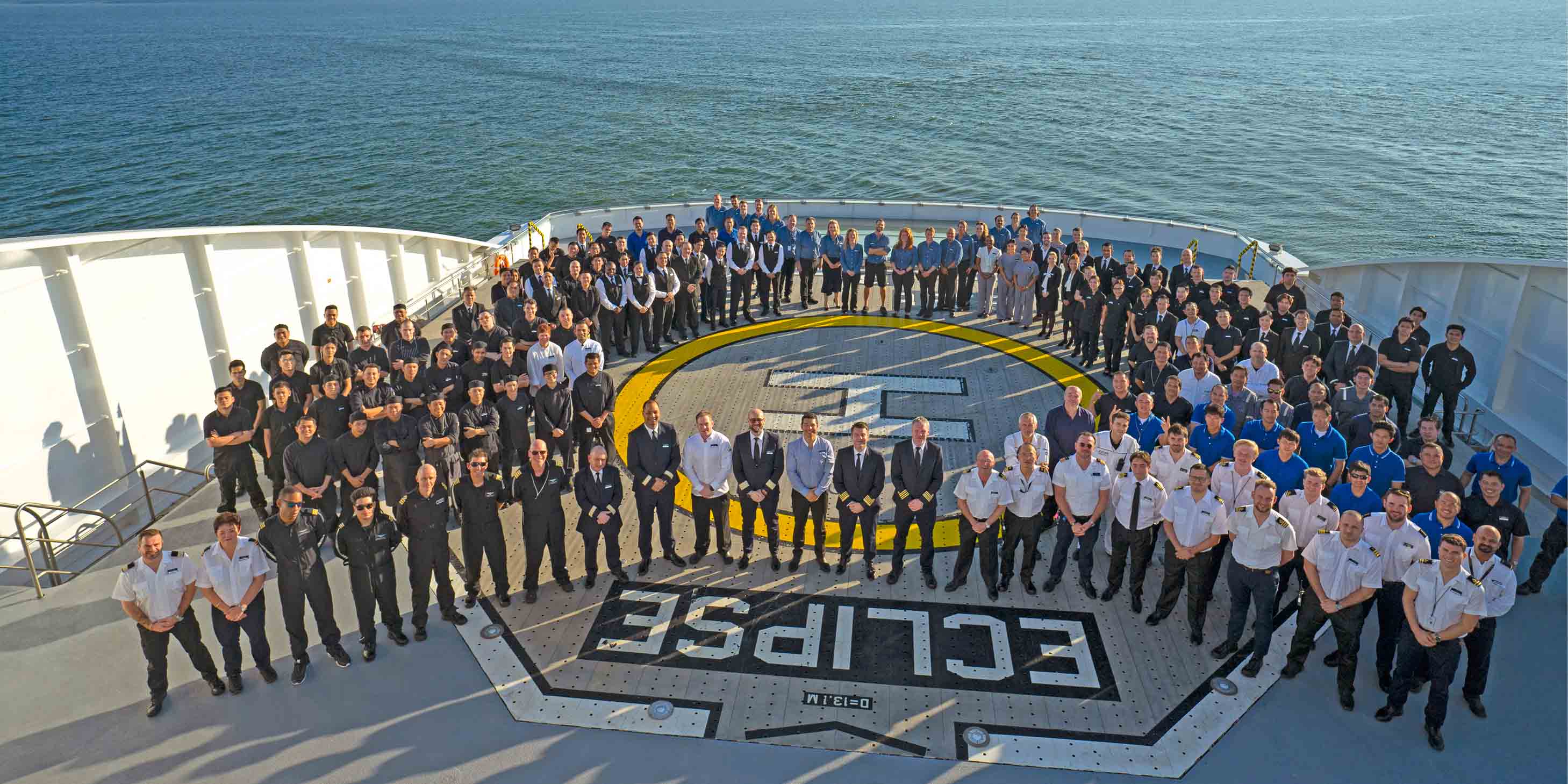 Ocean ship crew standing on the helicopter landing pad 